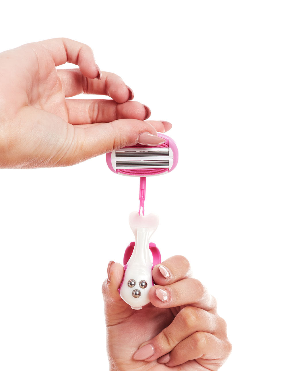 Woman taking off the blade cartridge head of a pink razor