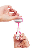 Woman taking off the blade cartridge head of a pink razor