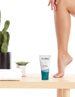Aveline botanical body lotion on a wooden surface with a cactus plant in the background